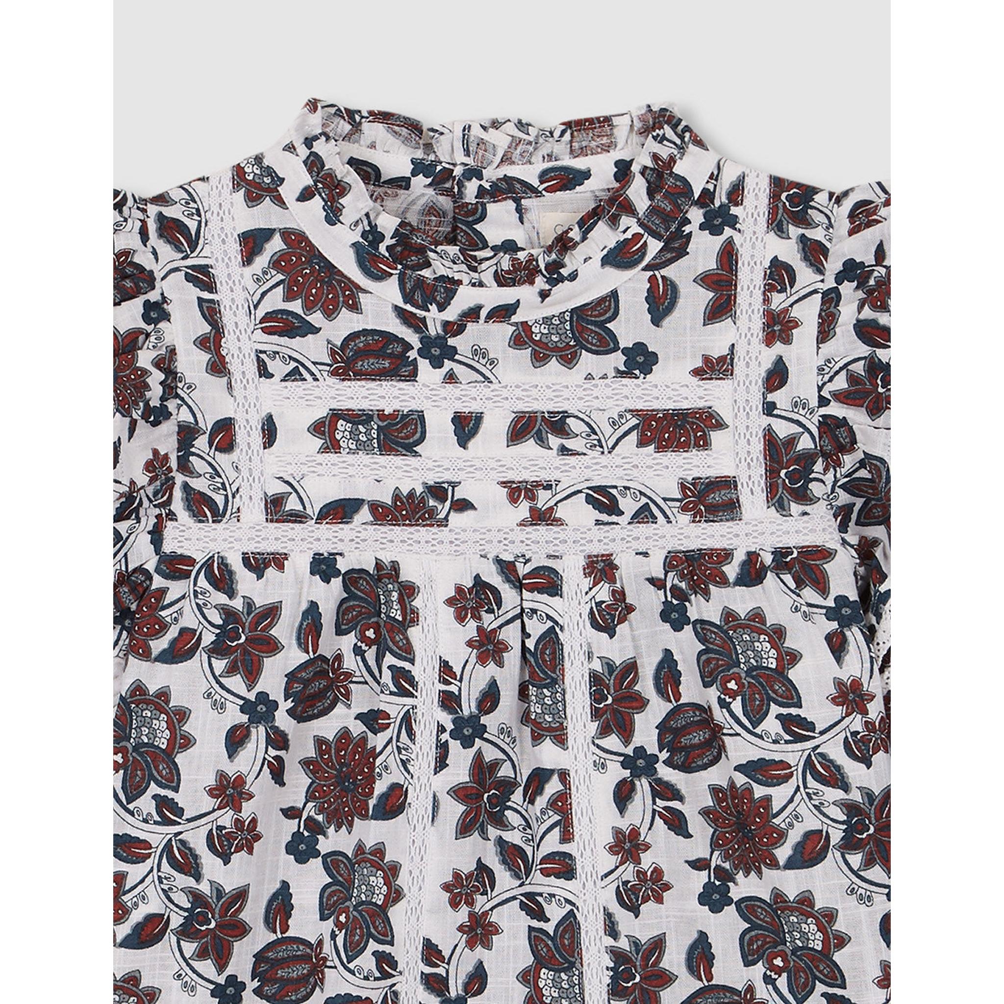 Blusa floral con volantes y tiras bordadas blanco