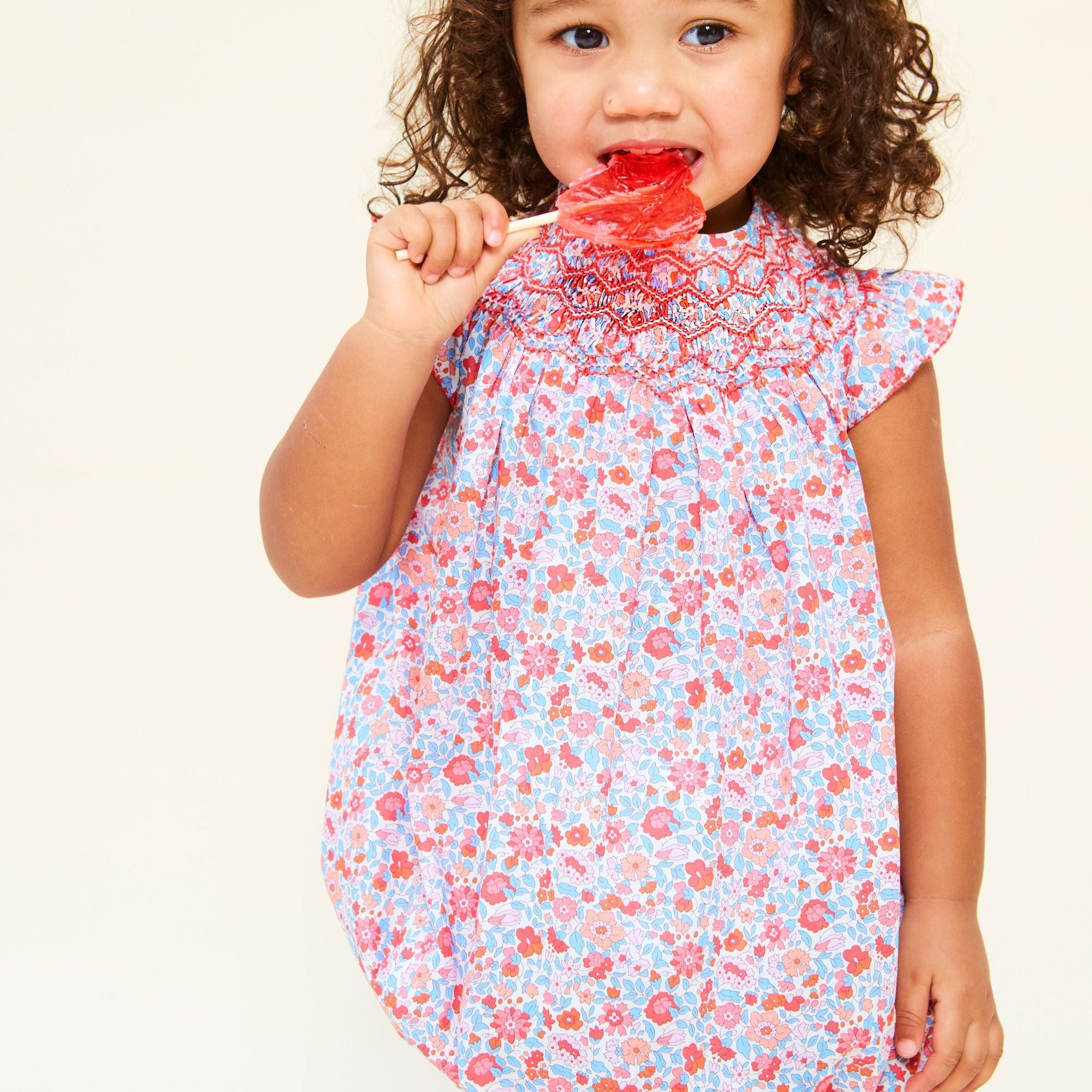 COCO ROMPER WITH CARNATION HAND SMOCKING MADE WITH LIBERTY THERESA PINK